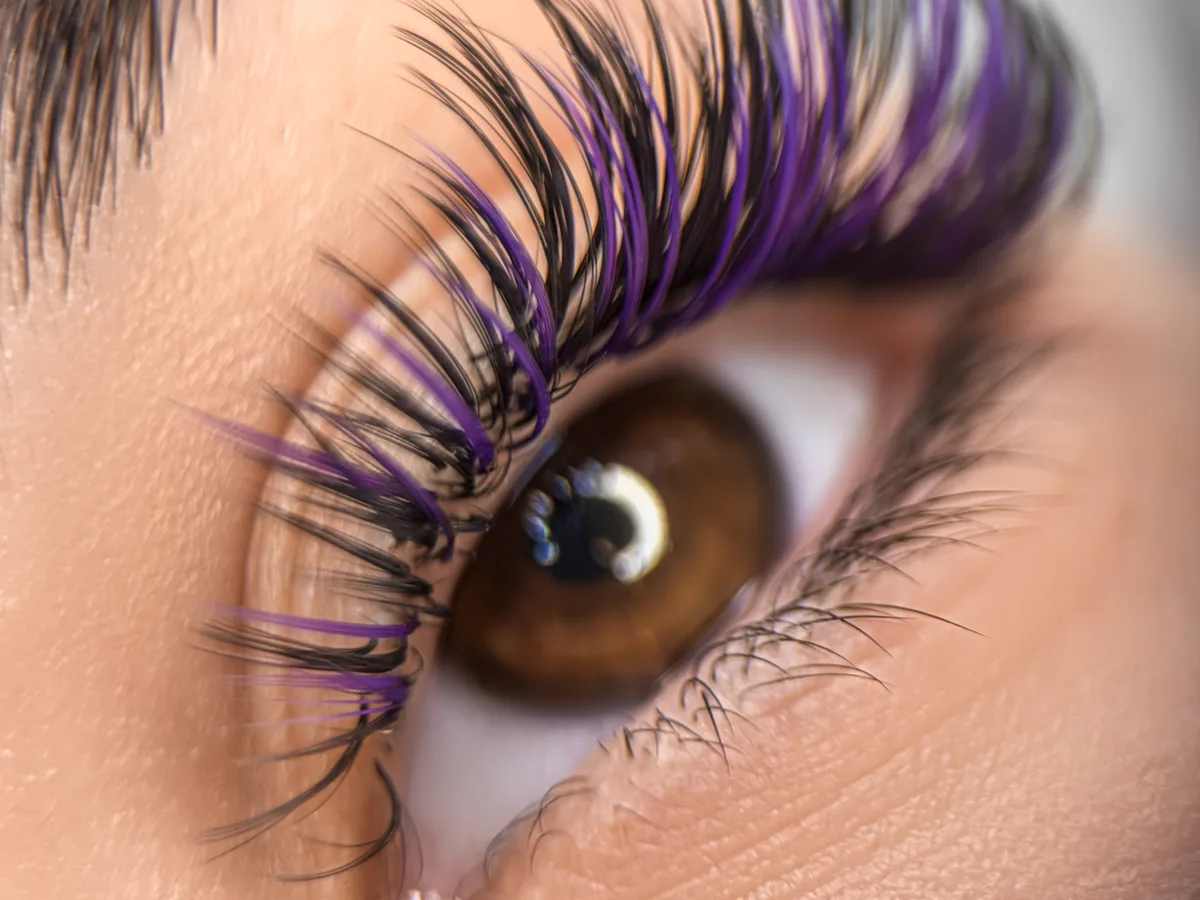 Extreme close-up of a fresh set of full lash extensions framing the eye, editorial beauty photography